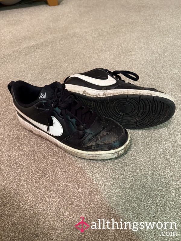 Well-worn Muddy Nike Trainers