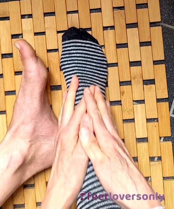 Putting On Black/silver Striped Socks On Bare Feet (30 Sec)