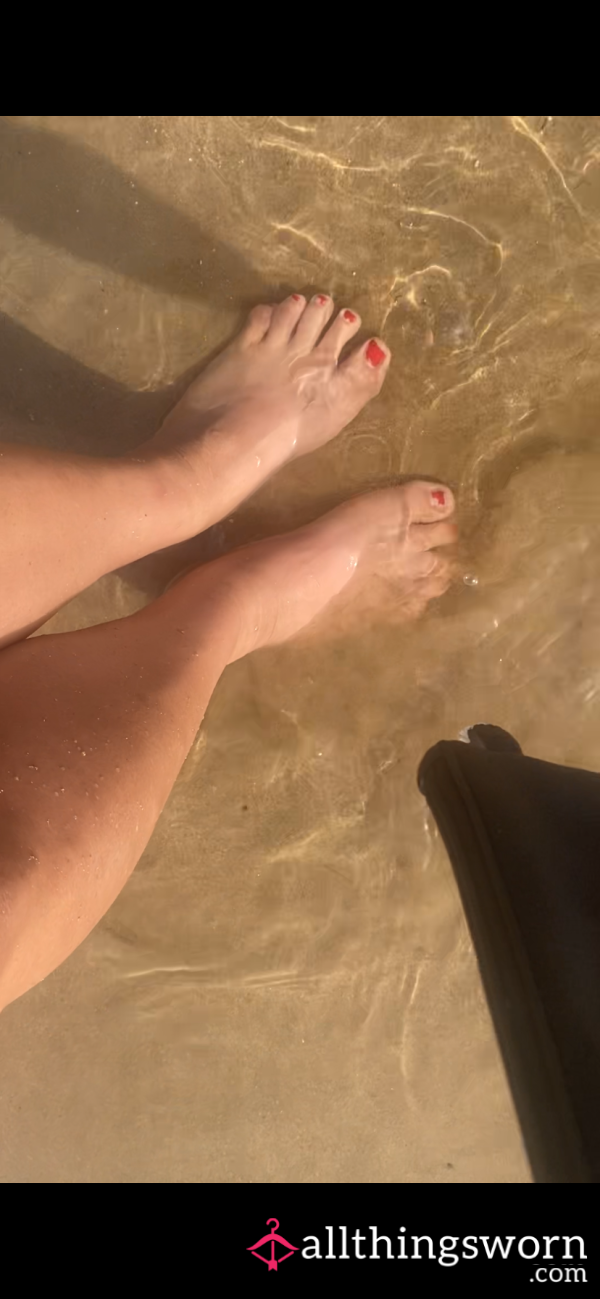 Wet Dirty Feet Walking Through Sand And Sea