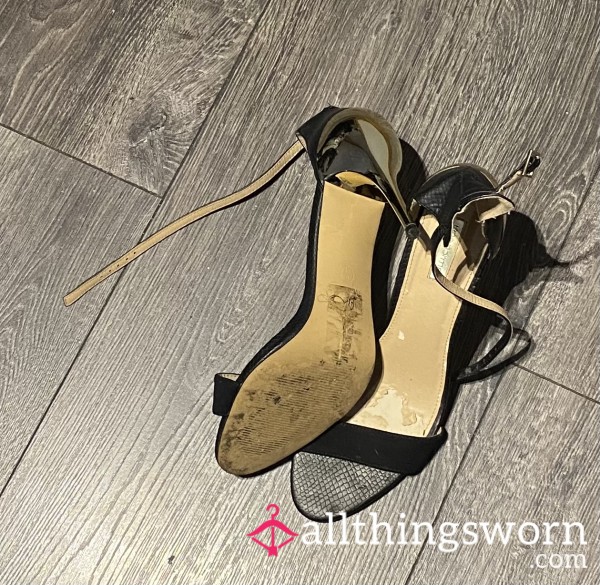 Worn Gold And Black Stiletto Shoes